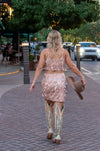 Vegas Nights + Rodeo Lights: The NFR Collection. Two piece chandelier fringe skirt and top paired with cowboy hat. rose gold sequins. 