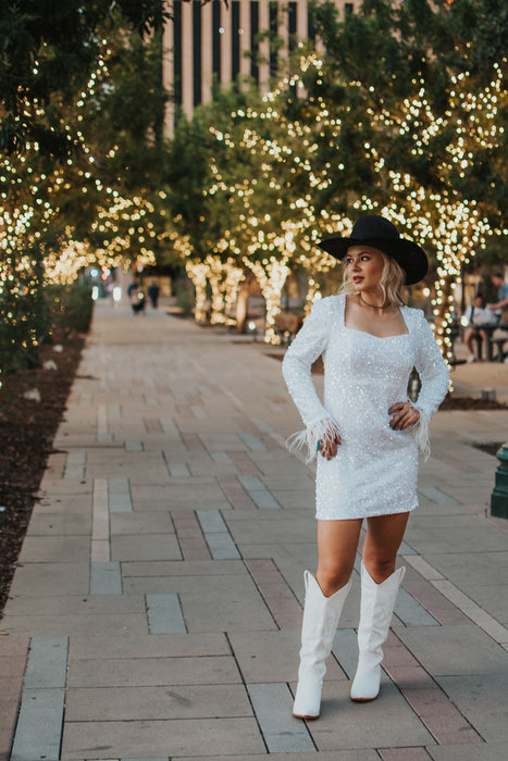 Vegas Nights + Rodeo Lights: The NFR Collection.  white sequin + iridescent sequin midi dress with feather trim.