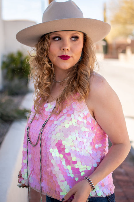 This flattering tank has rows of pink iridescent disc sequins to ensure that every eye will be on you. It has adjustable straps and is the perfect night out top. shop sequin tops near me, boutique near me