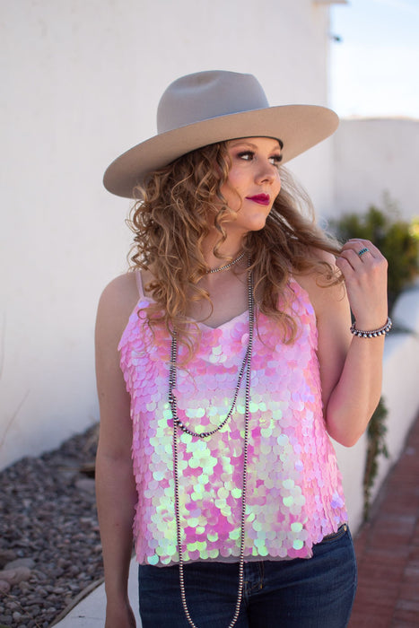 This flattering tank has rows of pink iridescent disc sequins to ensure that every eye will be on you. It has adjustable straps and is the perfect night out top. 