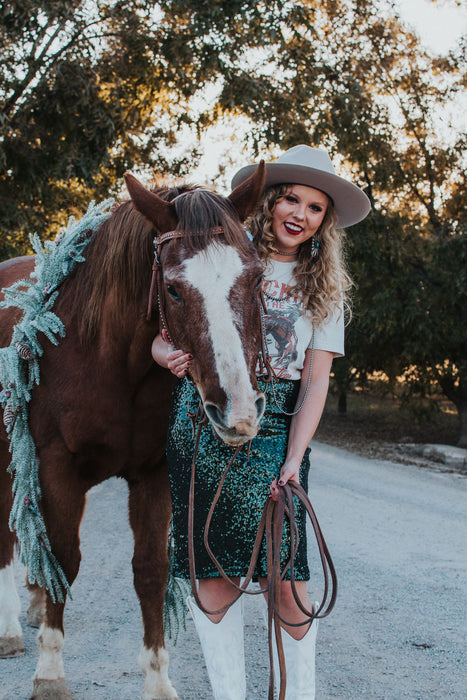 Make a statement this holiday season with the evergreen skirt! These hunter green sequins create a beautiful sparkle while the midi length fit creates a flattering silhouette.