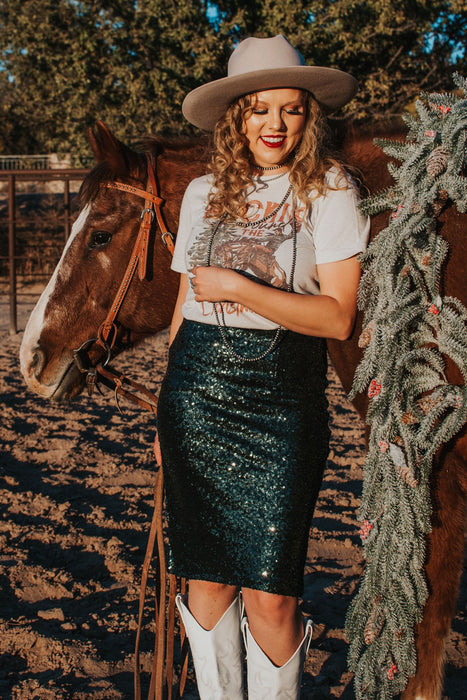 Make a statement this holiday season with the evergreen skirt! These hunter green sequins create a beautiful sparkle while the midi length fit creates a flattering silhouette.