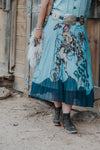 The Tasha Polizzi rodeo club skirt is a stunning chiffon skirt with a retro rodeo club bucking horse design. Designer Tasha Polizzi is based in the Berkshire mountains and creates one of a kind pieces. We love stocking this piece in our western boutique! Paired with carmelita woolie purse. 