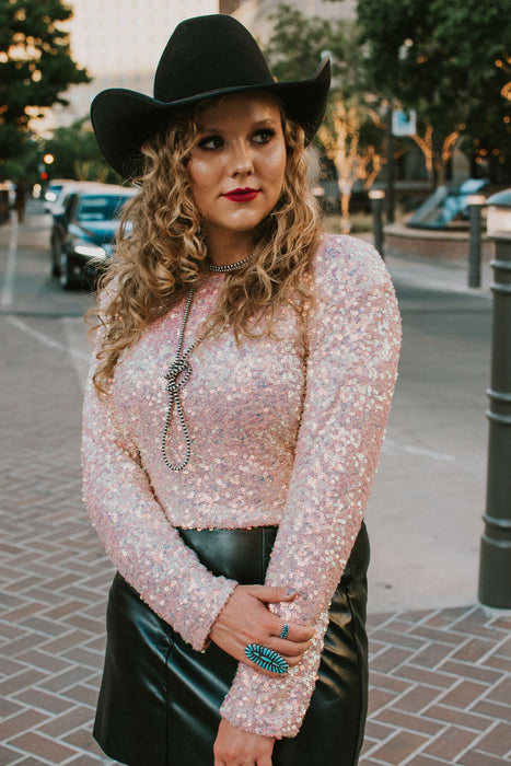 pink iridescent sequin crop top with padded shoulders.