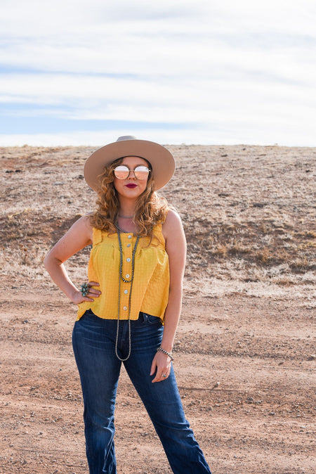 The perfect tanks for spring! These woven knit, square neck tops have adjustable straps and decorative button detailing. They come in two colors, sage and sunshine, but we think there's a chance you might need both.