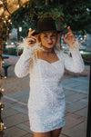 Vegas Nights + Rodeo Lights: The NFR Collection. white sequin + iridescent sequin midi dress with feather trim.