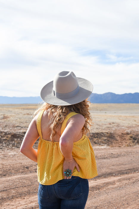 The perfect tanks for spring! These woven knit, square neck tops have adjustable straps and decorative button detailing. They come in two colors, sage and sunshine, but we think there's a chance you might need both.