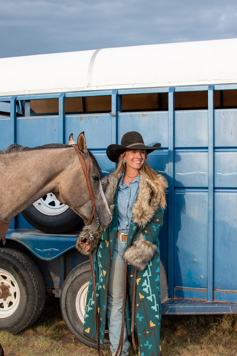 These Tasha Polizzi pieces are the definition of high fashion on the ranch. This peacock Everest blanket coat has a stunning aztec pattern and fur trim on the collar and cuffs, making for a truly one of a kind jacket.