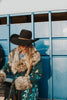 These Tasha Polizzi pieces are the definition of high fashion on the ranch. This peacock Everest blanket coat has a stunning aztec pattern and fur trim on the collar and cuffs, making for a truly one of a kind jacket.