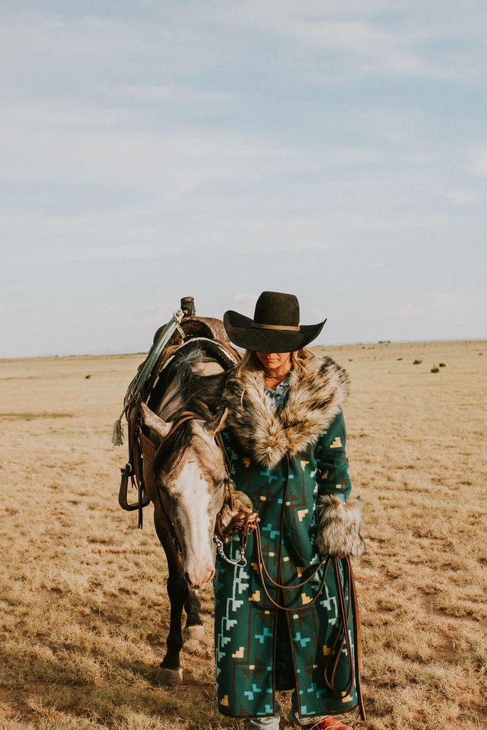 These Tasha Polizzi pieces are the definition of high fashion on the ranch. This peacock Everest blanket coat has a stunning aztec pattern and fur trim on the collar and cuffs, making for a truly one of a kind jacket.