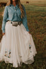 Our Nashville skirt is what dreams are made of! This full length skirt has layers of white tulle and is embellished with sequin cowboy boots. Perfect for styling and twirling!