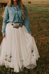 Our Nashville skirt is what dreams are made of! This full length skirt has layers of white tulle and is embellished with sequin cowboy boots. Perfect for styling and twirling!