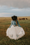 Our Nashville skirt is what dreams are made of! This full length skirt has layers of white tulle and is embellished with sequin cowboy boots. Perfect for styling and twirling!