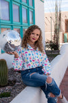 Girls just wanna have fun... outfits, and this top is about as fun as it gets. This blouse has a graphic print with disco balls, cowboy hats and tequila bottles. This shirt is SO flattering while still being super comfortable.