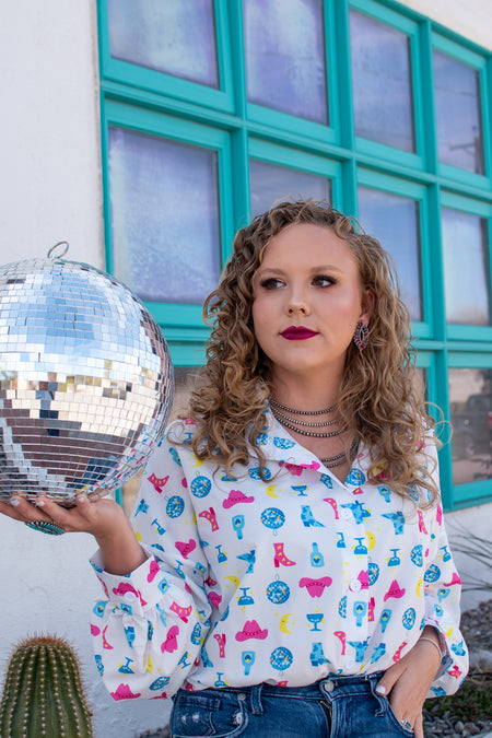 Western boutique offering western button down shirt with disco balls, cowboy hat, and tequila print. Paired with navajo pearls and authentic native american jewelry. Disco cowboy, constellation cowboy, nashville cowgirl inspiration.