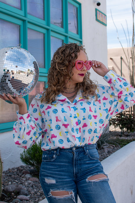 Girls just wanna have fun... outfits, and this top is about as fun as it gets. This blouse has a graphic print with disco balls, cowboy hats and tequila bottles. This shirt is SO flattering while still being super comfortable.