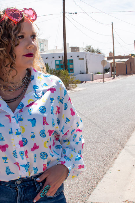 Girls just wanna have fun... outfits, and this top is about as fun as it gets. This blouse has a graphic print with disco balls, cowboy hats and tequila bottles. This shirt is SO flattering while still being super comfortable.